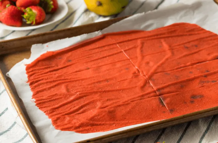 Freshly dehydrated strawberry fruit leather still on the pan.